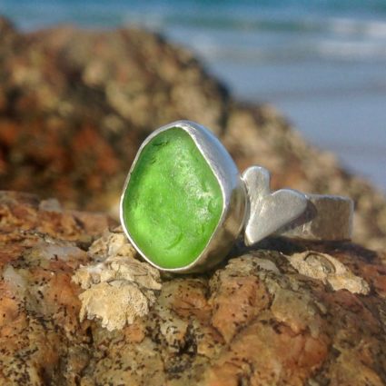 Emerald green Guernsey sea glass ring with sterling silver band and heart detail.