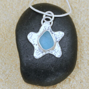 Handcrafted sterling silver starfish with pale aqua Guernsey seagrass.