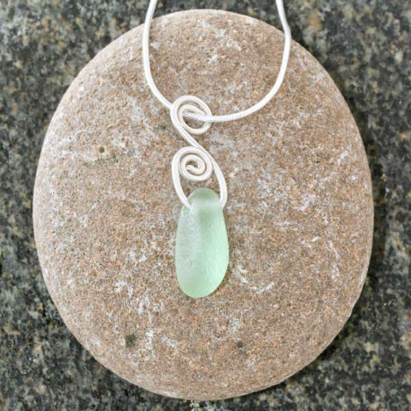 A beautiful Guernsey sea glass pendant handcrafted using fine and sterling silver.