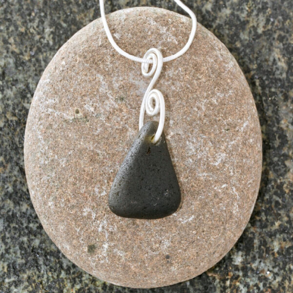 A beautiful Guernsey sea glass pendant handcrafted using fine and sterling silver.