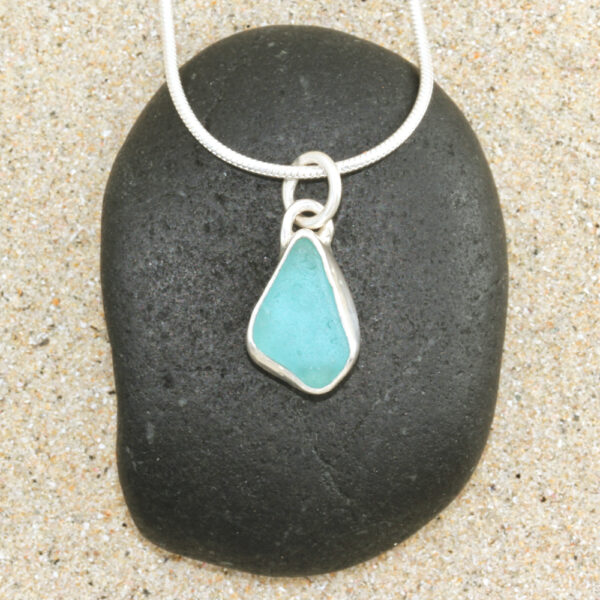 A beautiful petite Guernsey sea glass pendant handcrafted using fine and sterling silver.