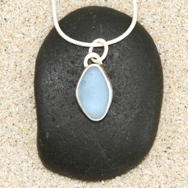 A beautiful petite Guernsey sea glass pendant handcrafted using fine and sterling silver.